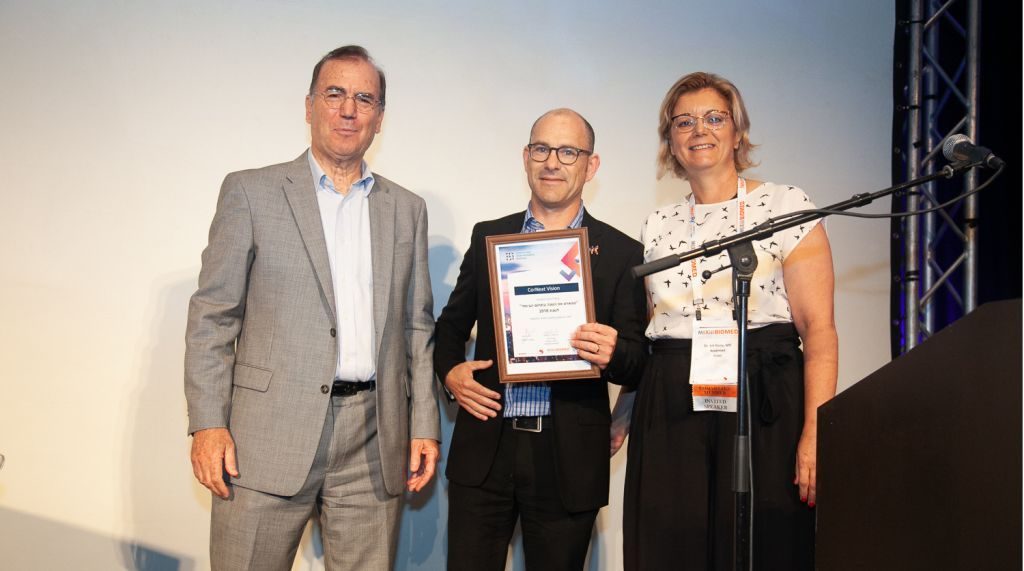 Dr. Ami Appelbaum, chairman of the Israel Innovation Authority-and-Dr. Irit Yaniv of Accelmed stand with winner Dr. Gilad Litvin chief medical Officer for CorNeat Vision.Biomed-2018-Start-up-Competition